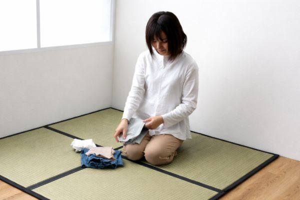 置き畳の上で洗濯物をたたむ